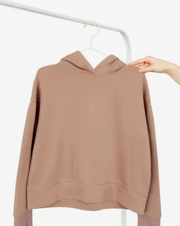 A dusty-pink hoodie on a hanger.